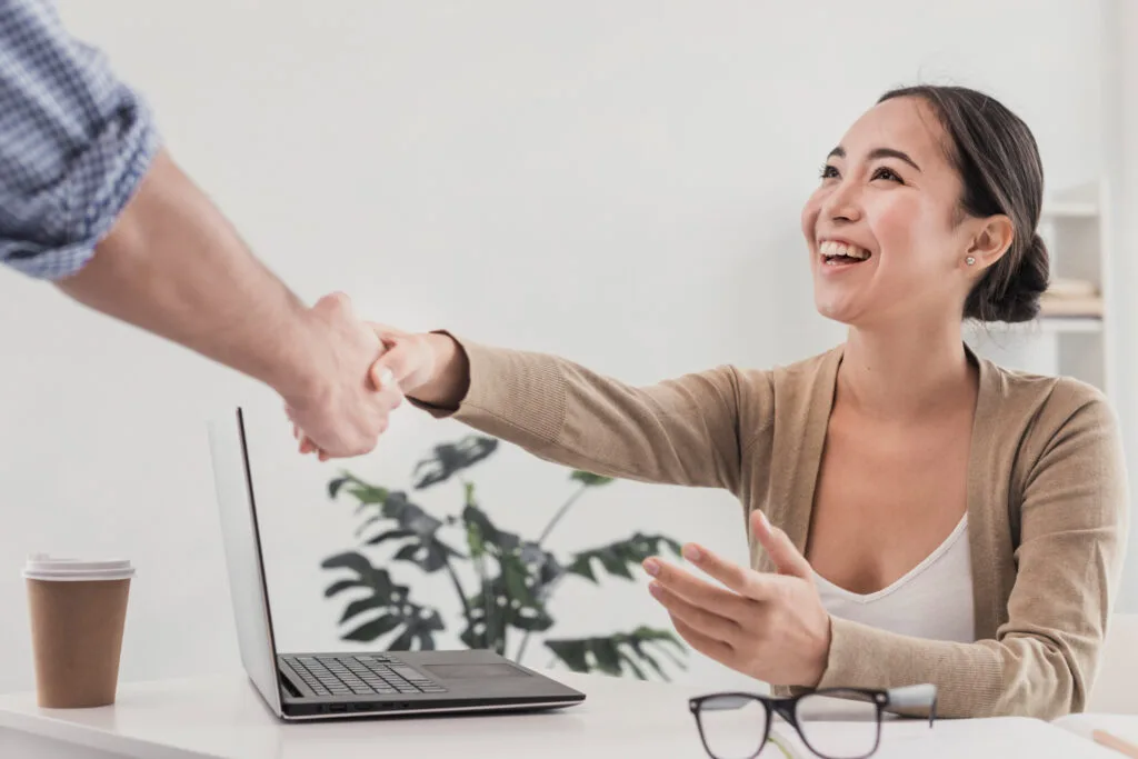 Office employee shaking hands with a customer