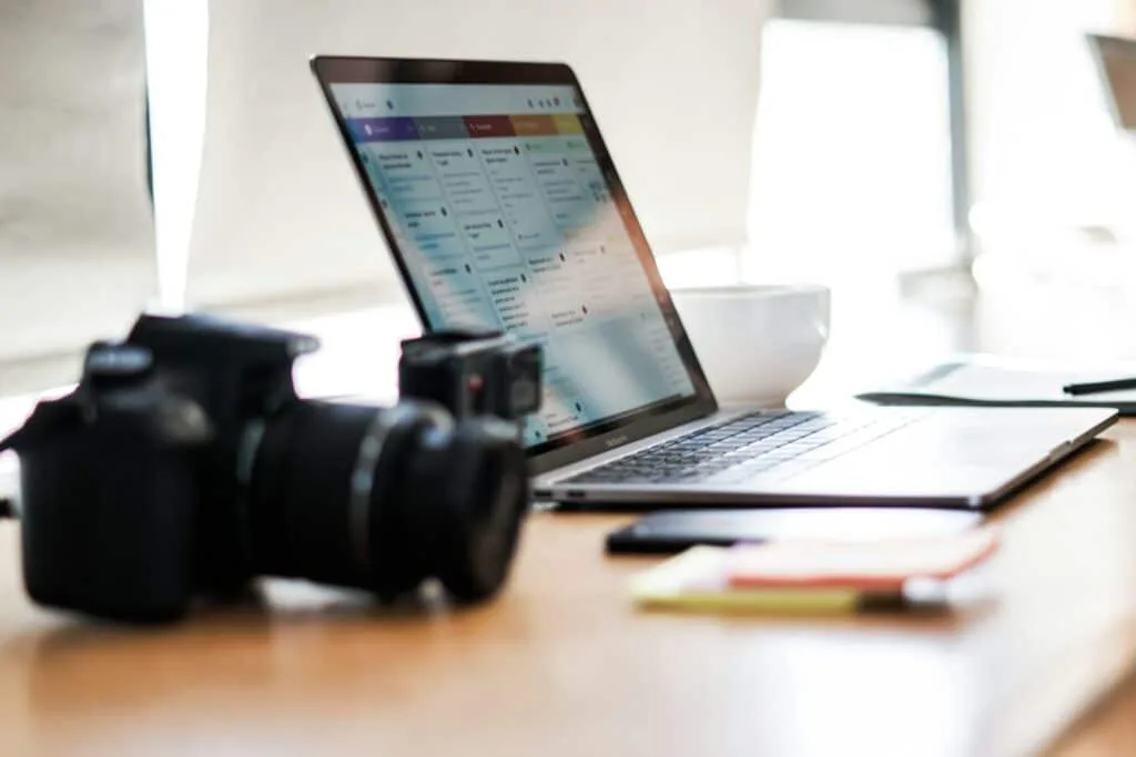 black dslr camera on top of a wooden table