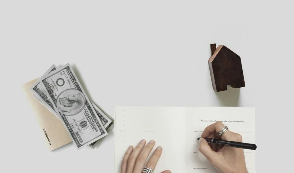 Budgeting concept. A person writing a note on top of a table.