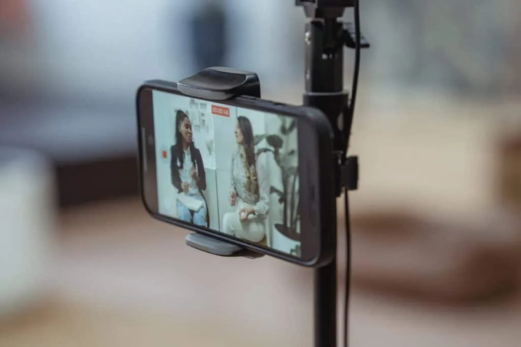 two girls creating video content on a mobile phone