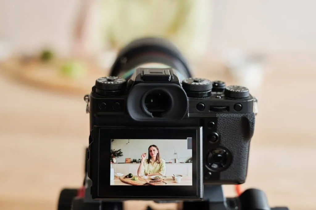A woman taking a video on digital camera