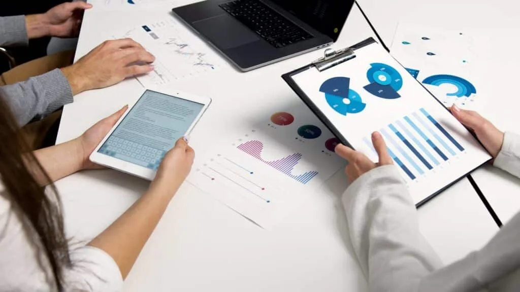 two people holding a tablet inside a meeting room