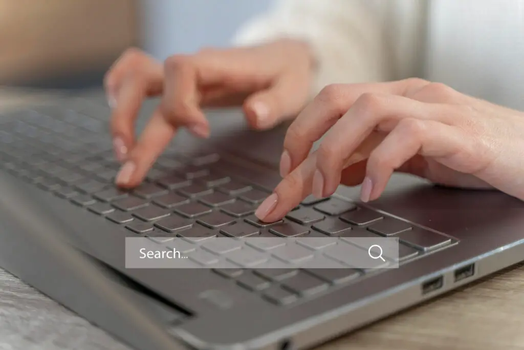 man searching on google using a laptop