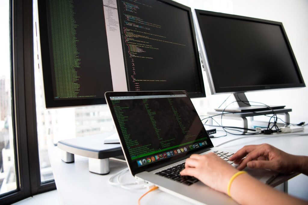 person programming and coding on a laptop computer