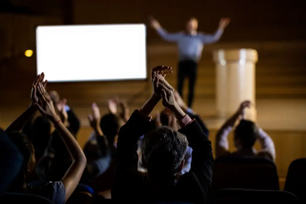 Audience applauding speaker at an event
