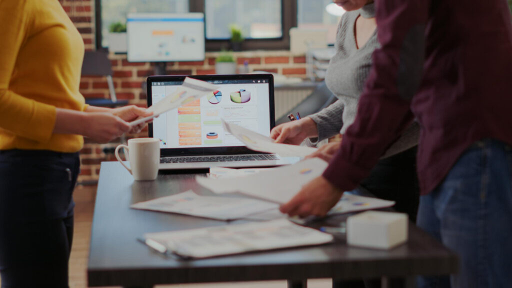 people in marketing agency holding papers