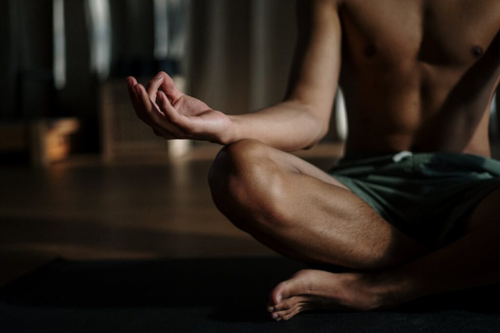 A man practicing yoga on the floor.