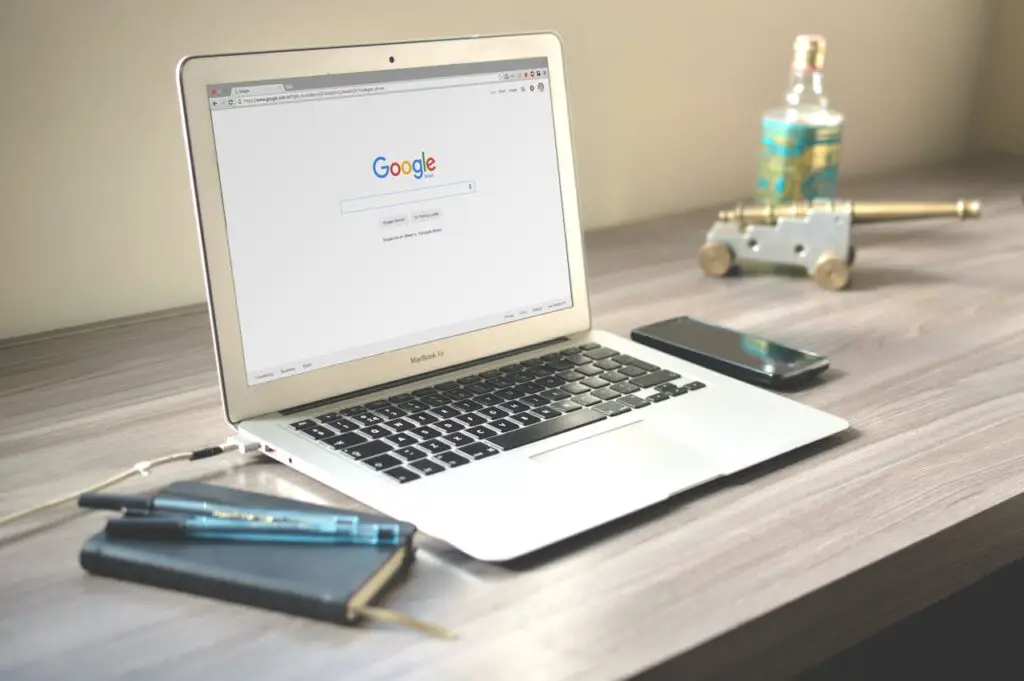 Laptop with open Google Search window sitting on top of a table