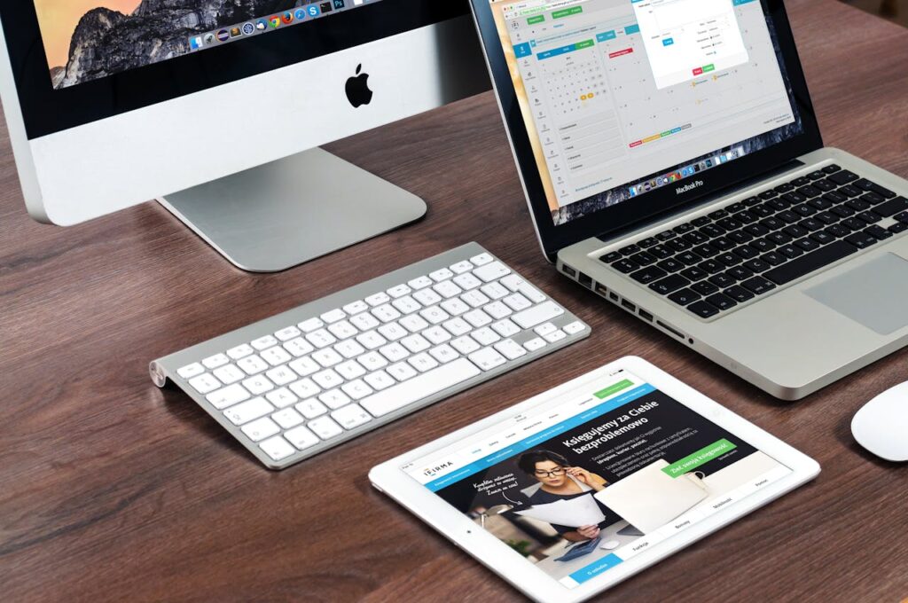 Laptop, computer and tablet on top of a table