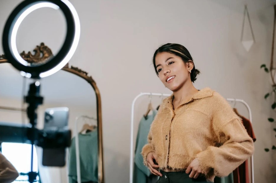 woman striking a pose in front of the ring light