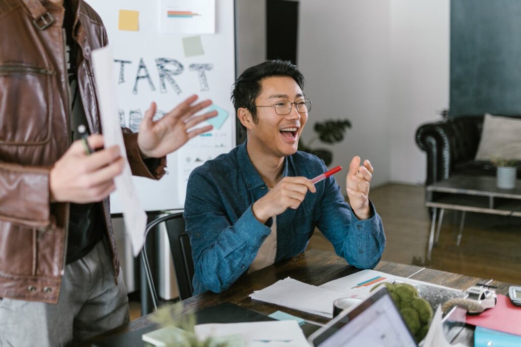 smiling man holding a pen