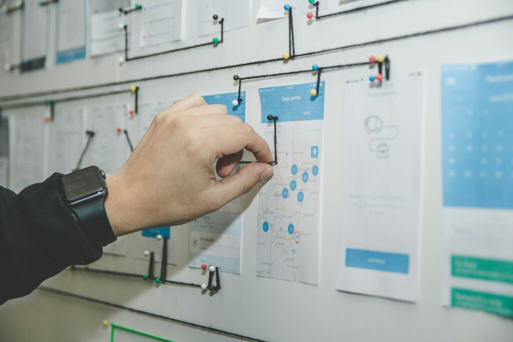 A person mapping a diagram on a white paper