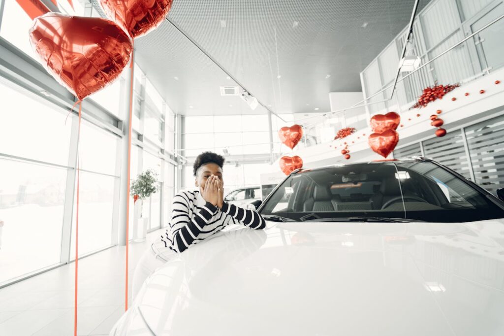 happy man right next to a white car