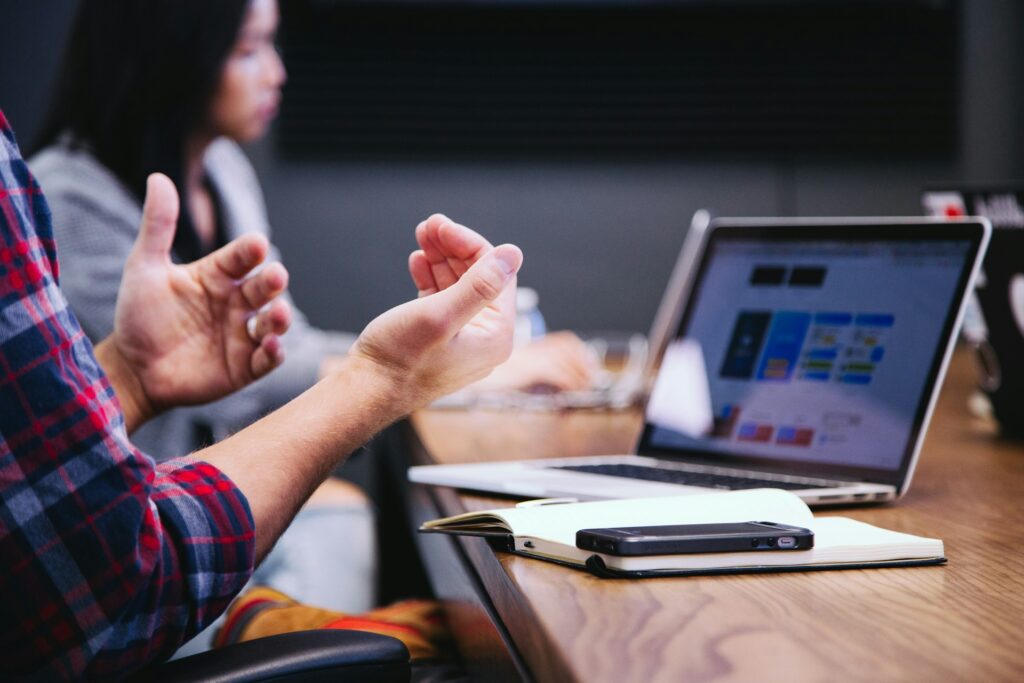 A man making hand gestures during a meeting.