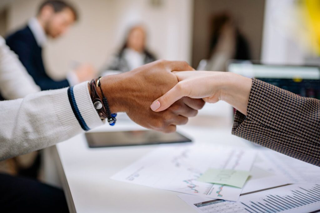 man shaking hands while on a meeting