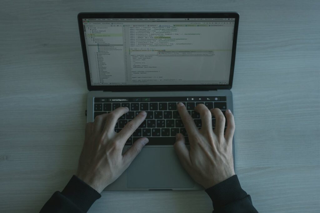 man coding on a laptop