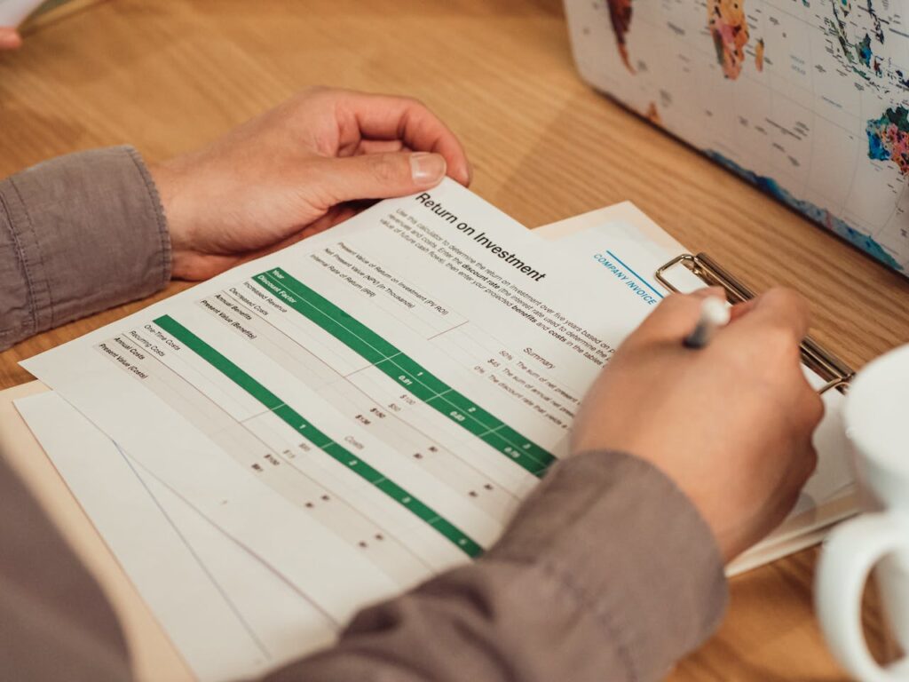 man holding a budget & Roi Tracking Sheet